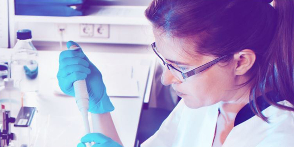Woman in a lab using pipette